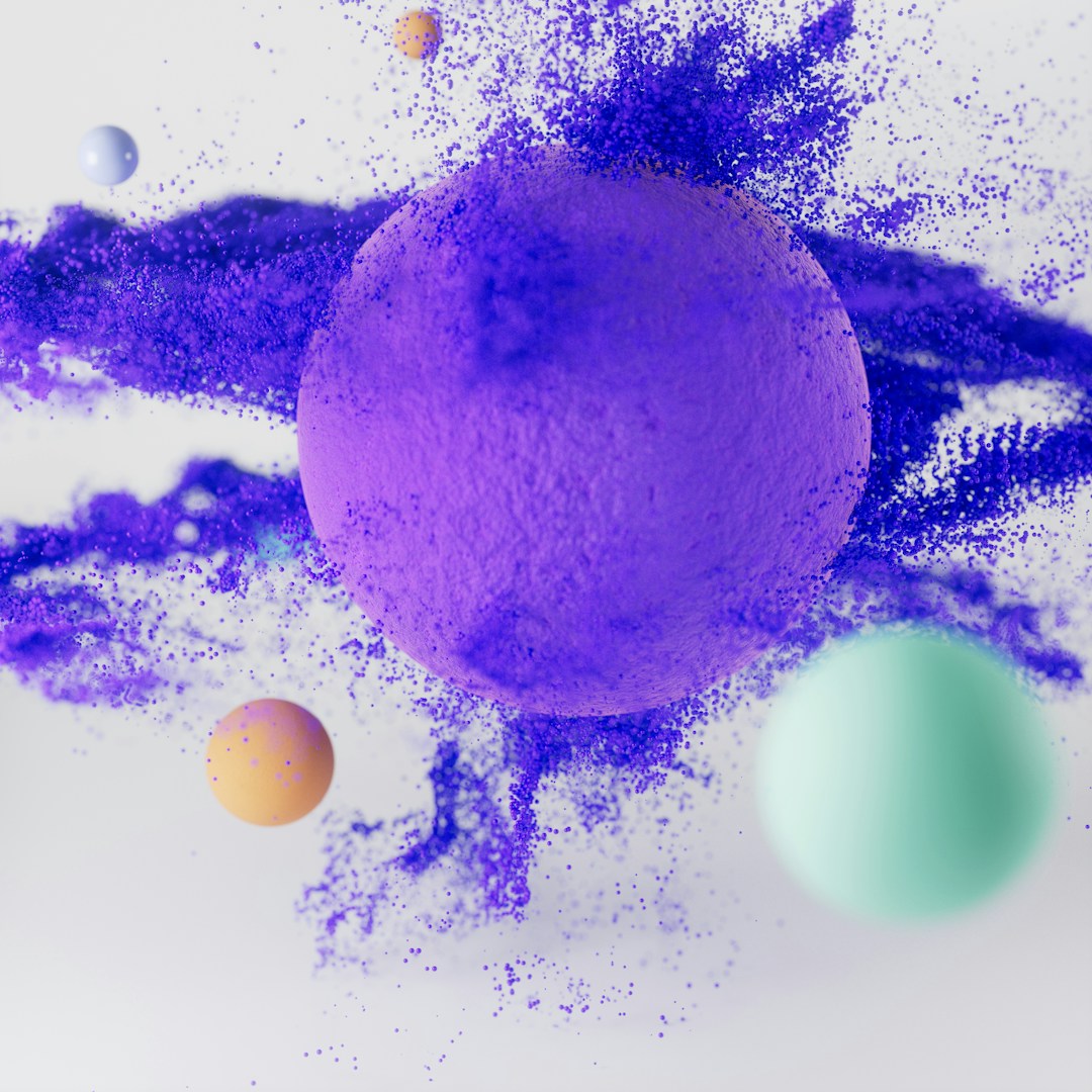 Purple sphere explodes with colorful particles.